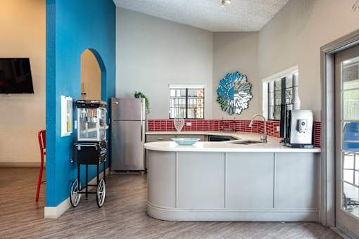 a kitchen with a counter top and a refrigerator and a sink