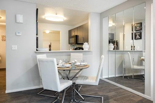 a dining room with a table and chairs and a kitchen