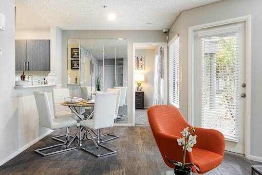 a living room and dining room with a table and chairs