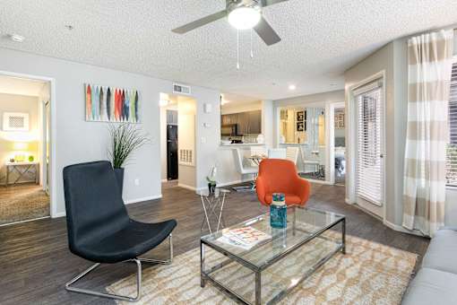 a living room with a couch and a glass table