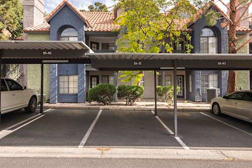 a parking lot with cars parked in front of a building
