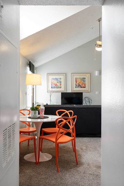 a dining room with a table and chairs and a living room