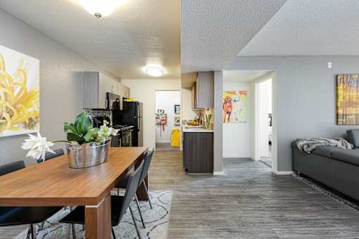 the living room and dining room of an apartment