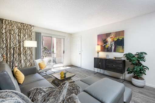 a living room with a gray couch and a tv
