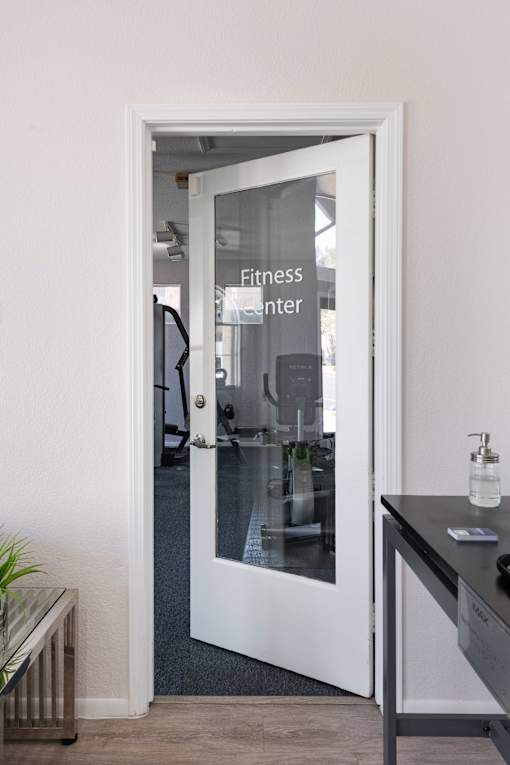 a glass door with a fitness center sign on it