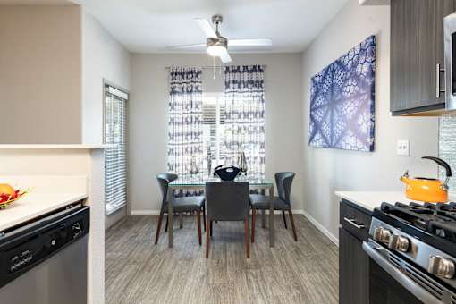 a kitchen and dining room area with a table and chairs and a stove