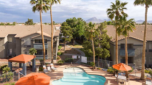 an aerial view of a pool at the resort with palm trees