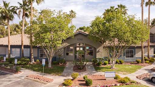 an exterior view of a building with palm trees