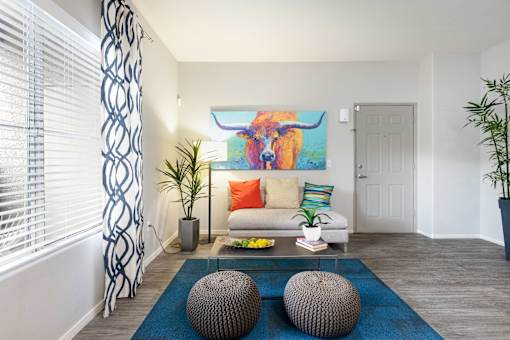 a living room with a couch and a painting of a bull