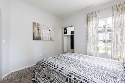 a bedroom with a bed and a window and a closet