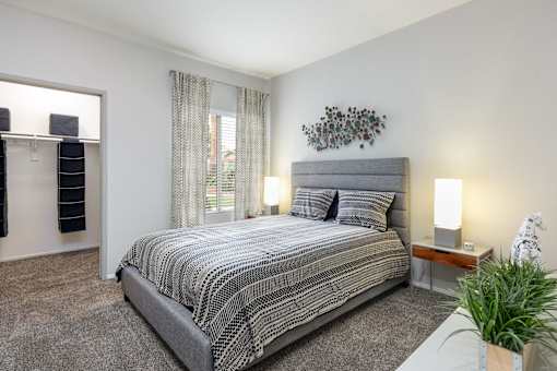a bedroom with a bed and a window and a closet