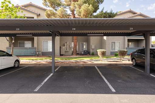 a parking lot with cars parked in front of a building