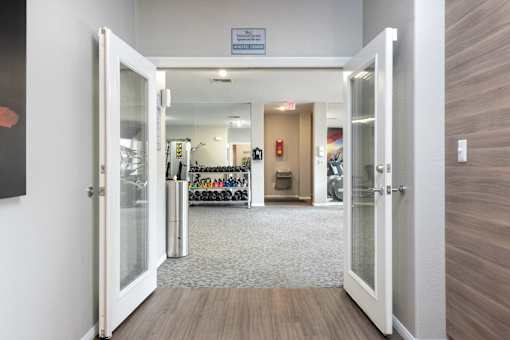 a view of a lobby with open doors and a wall with a bike rack