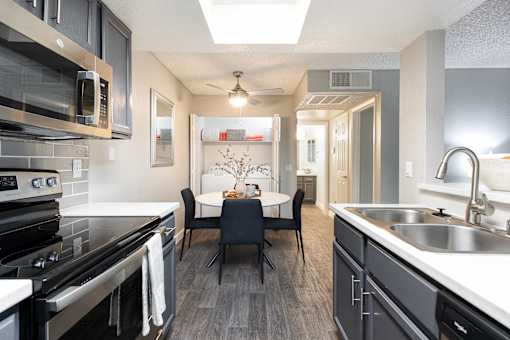 a kitchen and dining room with a table and chairs
