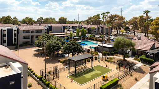 an aerial view of a park with a tennis court and a pool