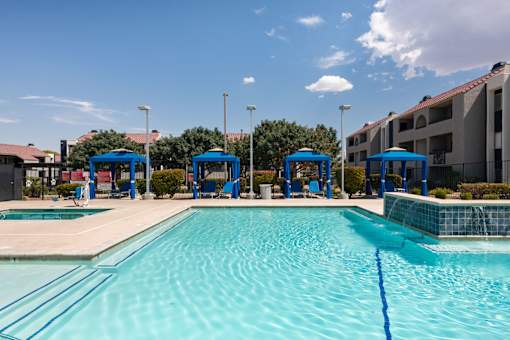 our apartments have a large swimming pool with blue cabanas