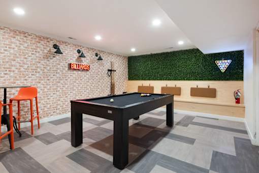 a game room with a pool table and a bar