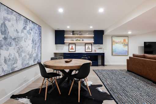 a living room and dining room with a table and chairs