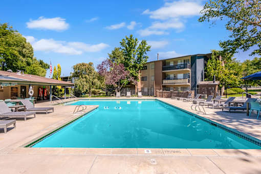 a swimming pool with a building in the background