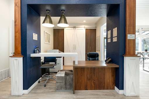 an office with a desk and a chair and a blue wall