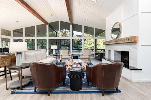 a living room with leather chairs and a fireplace