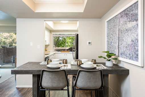 a kitchen and dining room with a table and chairs