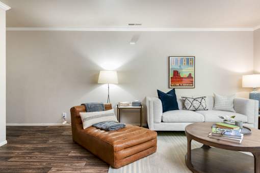a living room with a couch and a chair and a table