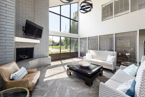 a living room with a couch and a table and a fireplace