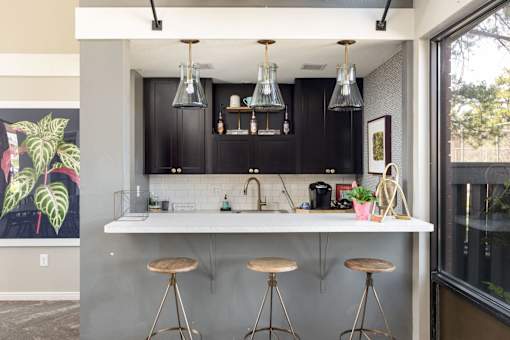 a kitchen with a counter and bar stools