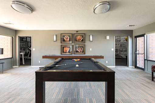 a room with a pool table in the middle of it