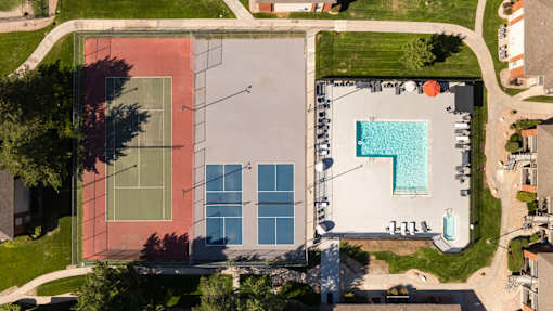 arial view of a building with a pool on the side of it