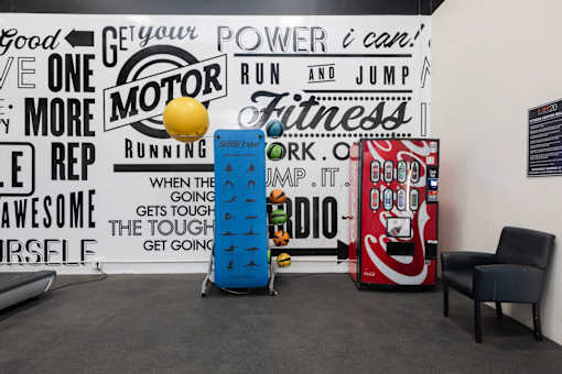 a room with two vending machines and a wall with graffiti on it