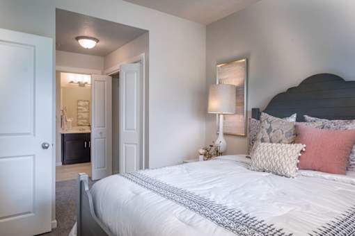 a bedroom with a bed and a door to a bathroom