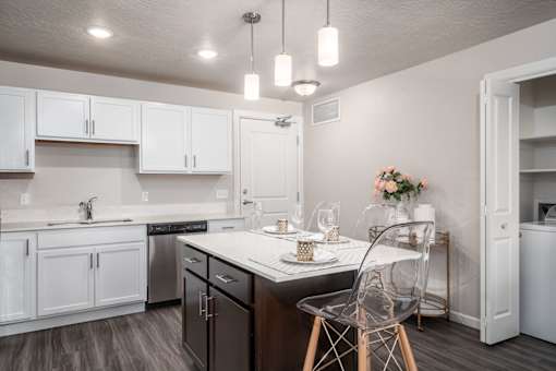a kitchen with white cabinets and a counter top