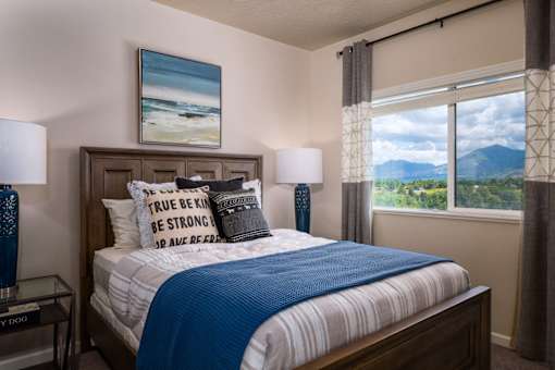 a bedroom with a bed and a window with mountain views