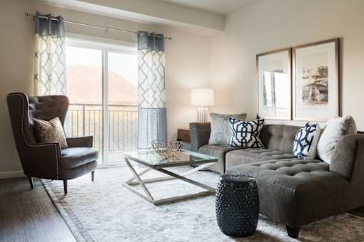 a living room with a couch and a chair and a table