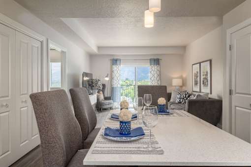 a dining room table with chairs in a living room