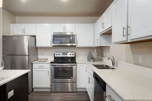 a kitchen with stainless steel appliances and white cabinets