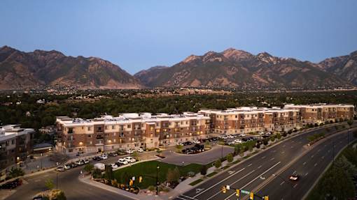 an aerial view of a city with mountains in the background