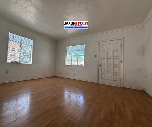 A room with wooden floors and a white door.