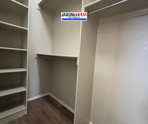 A walk-in closet with shelves