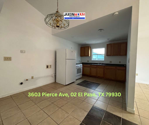A kitchen with a fridge and a dining table is for sale at 3603 Pierce Ave, 02 El Paso, TX 79930.