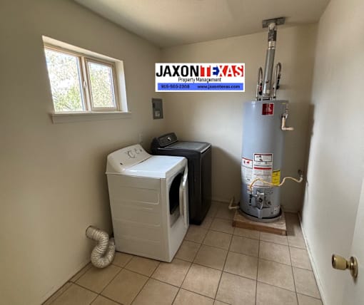 A small room with a washer and dryer and a water heater.