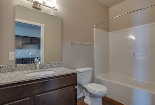 A bathroom with a toilet, sink, and bathtub.