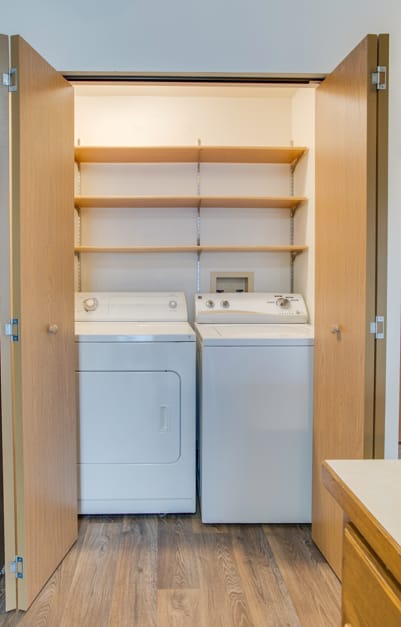 A small laundry room with a washer and dryer in it.