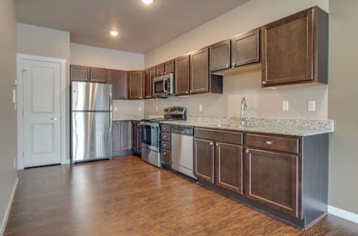 A kitchen with wooden cabinets and stainless steel appliances.