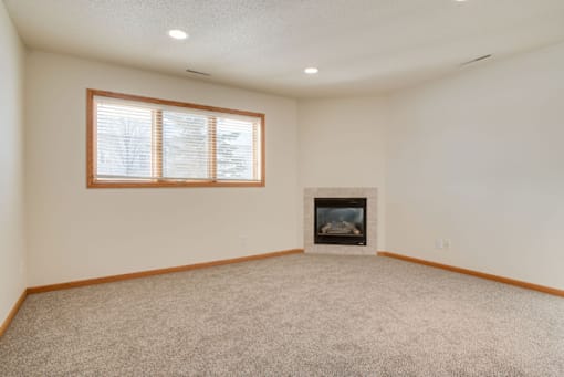 A room with a fireplace and a window.