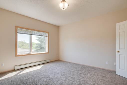 A room with a window and a door. at Eighth Street Manor  Apartments, Fargo, ND