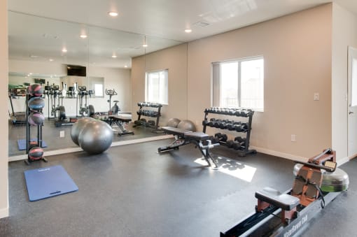 the spacious fitness center with weights and other exercise equipment at trillium apartments in fairfax at Beacon Estates  Apartments, Fargo, ND