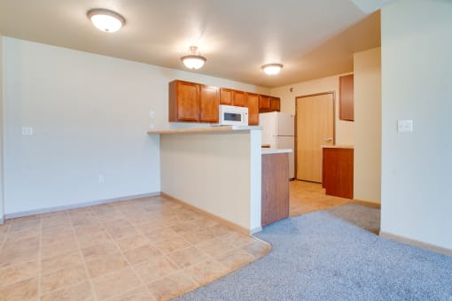a kitchen and living room with a microwave and a refrigerator at Waterstone Apartments, Moorhead, MN, 56560
